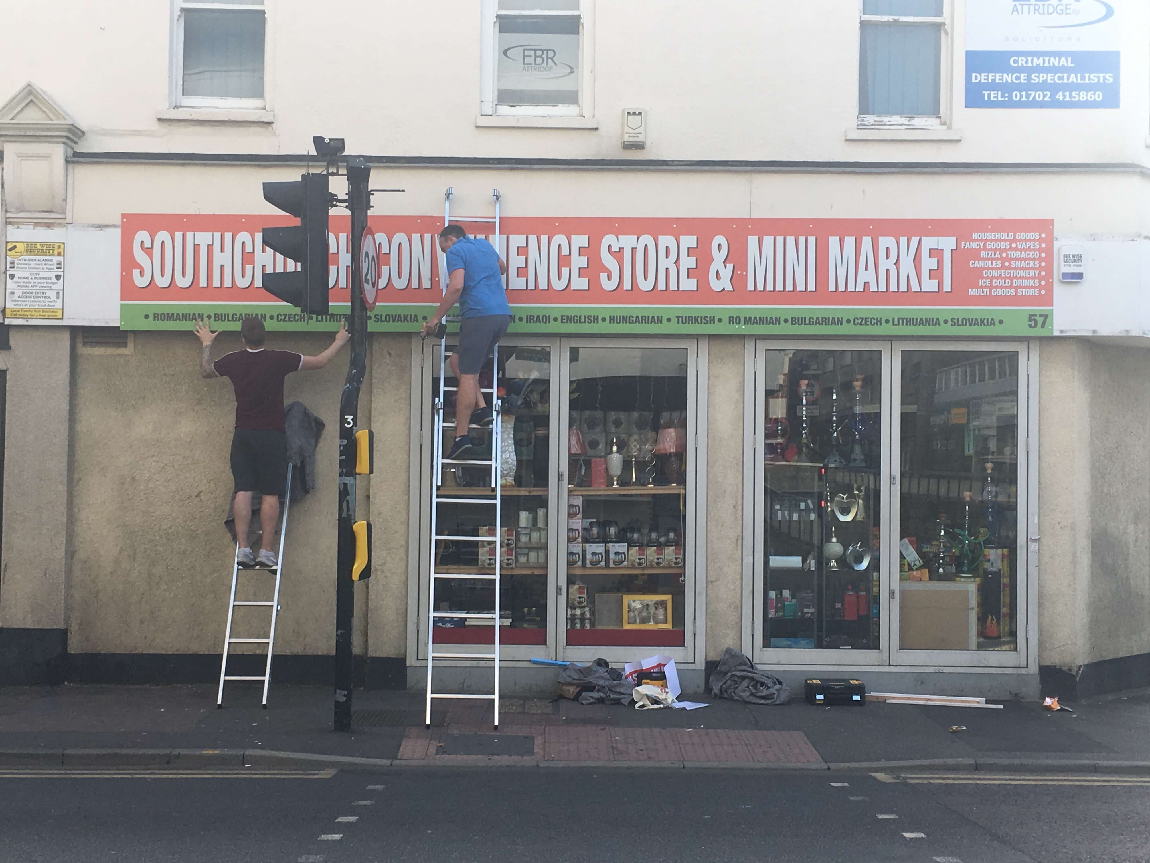 Shop sign being fitted